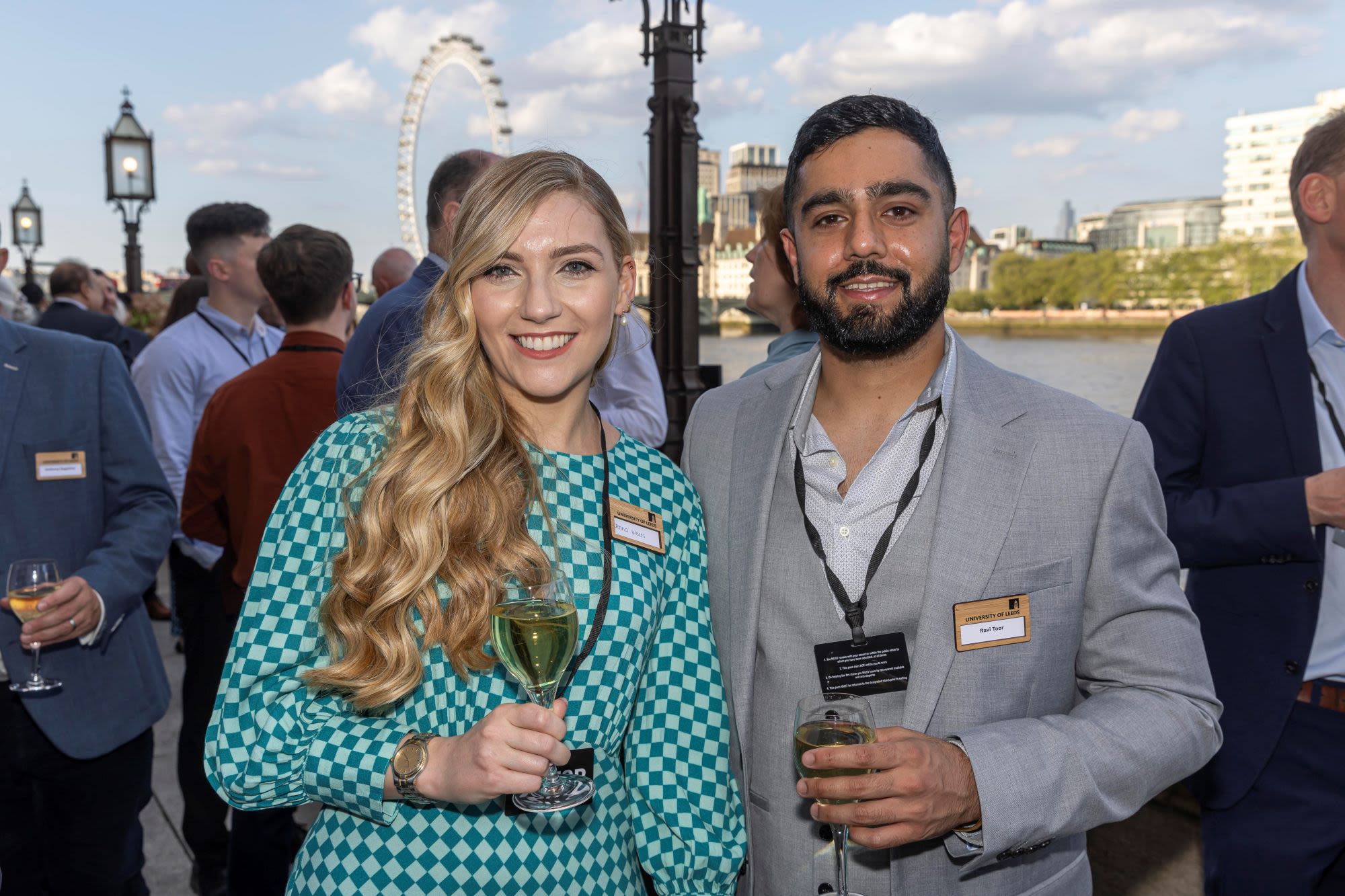 two people holding wine facing camera