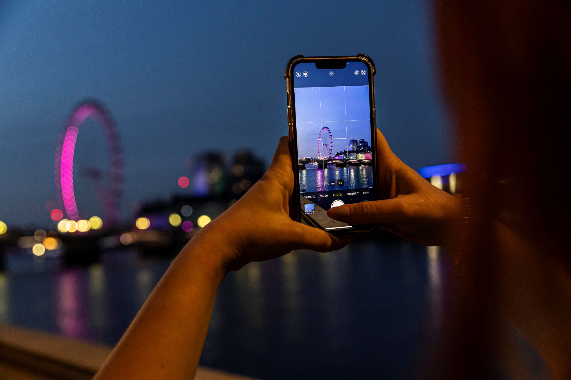 someone taking camera of London view in the evening