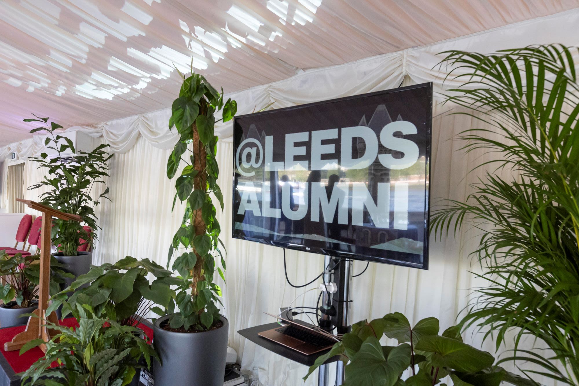 television screen saying @leedsalumni