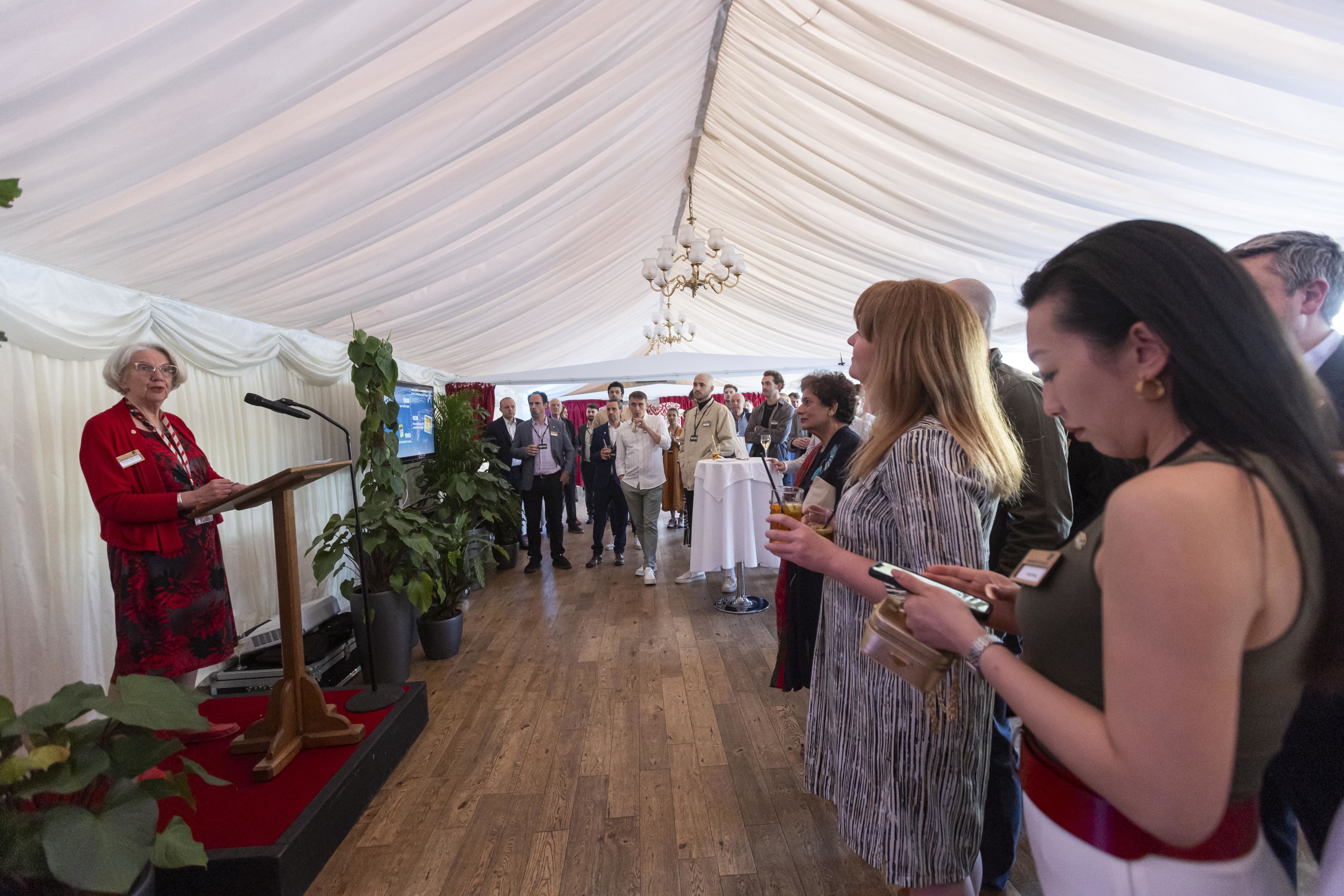 Woman giving speech in a marquee