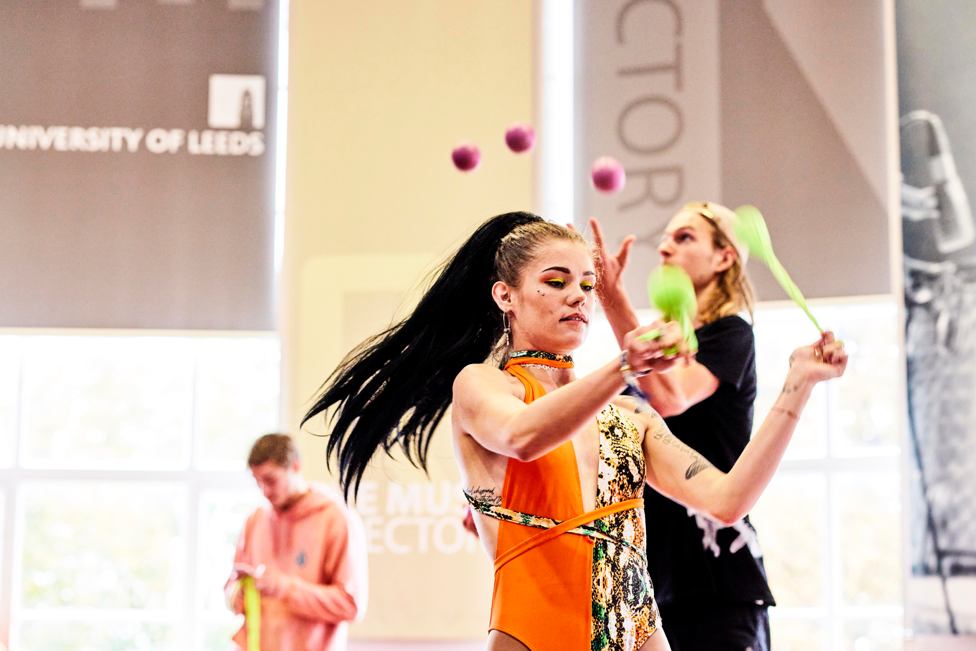 A performer juggles in the refectory