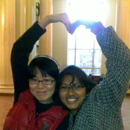 Two women posing for a photo, holding the arms aloft in the shape of a heart