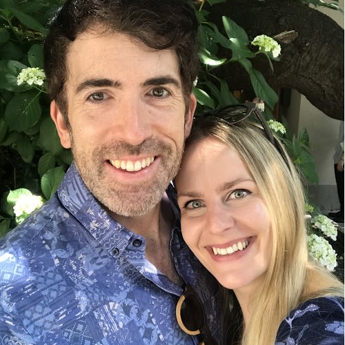 A selfie of a couple who are both smiling for the camera