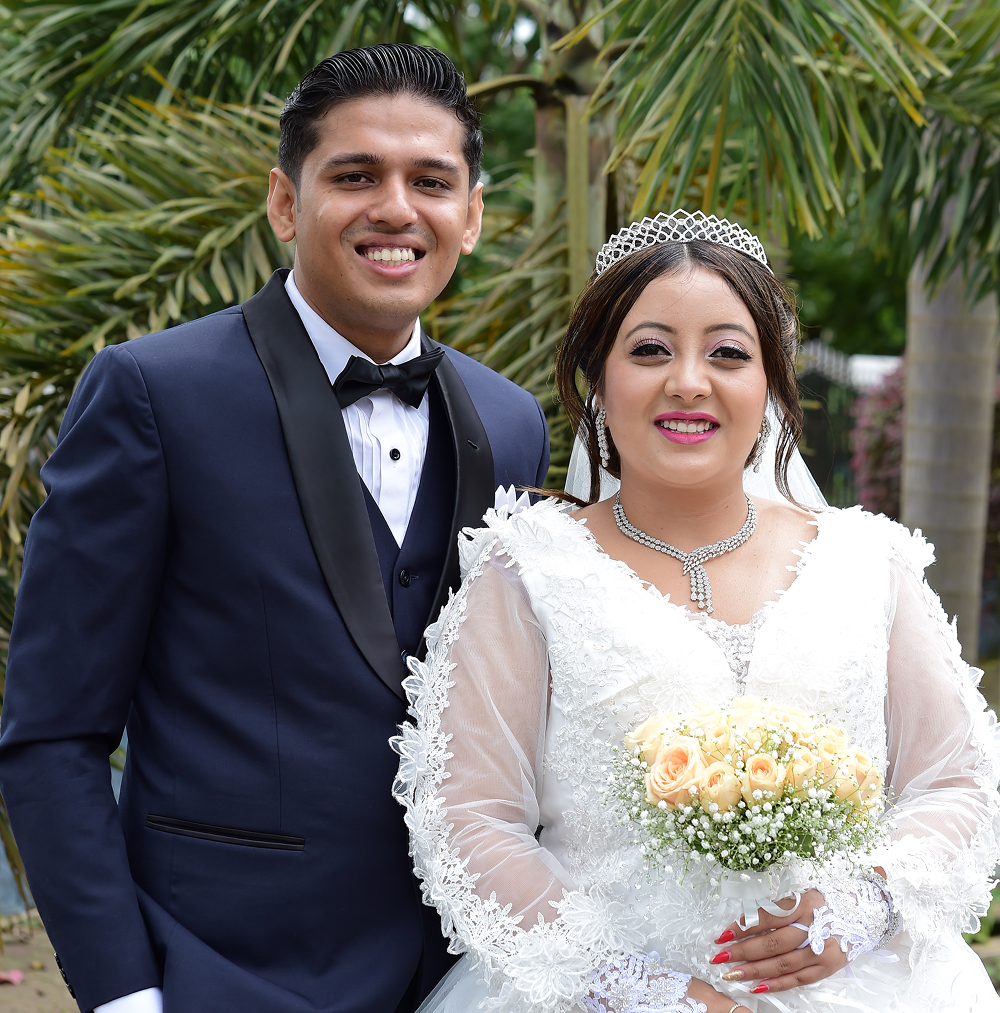 A couple stand together on their wedding day