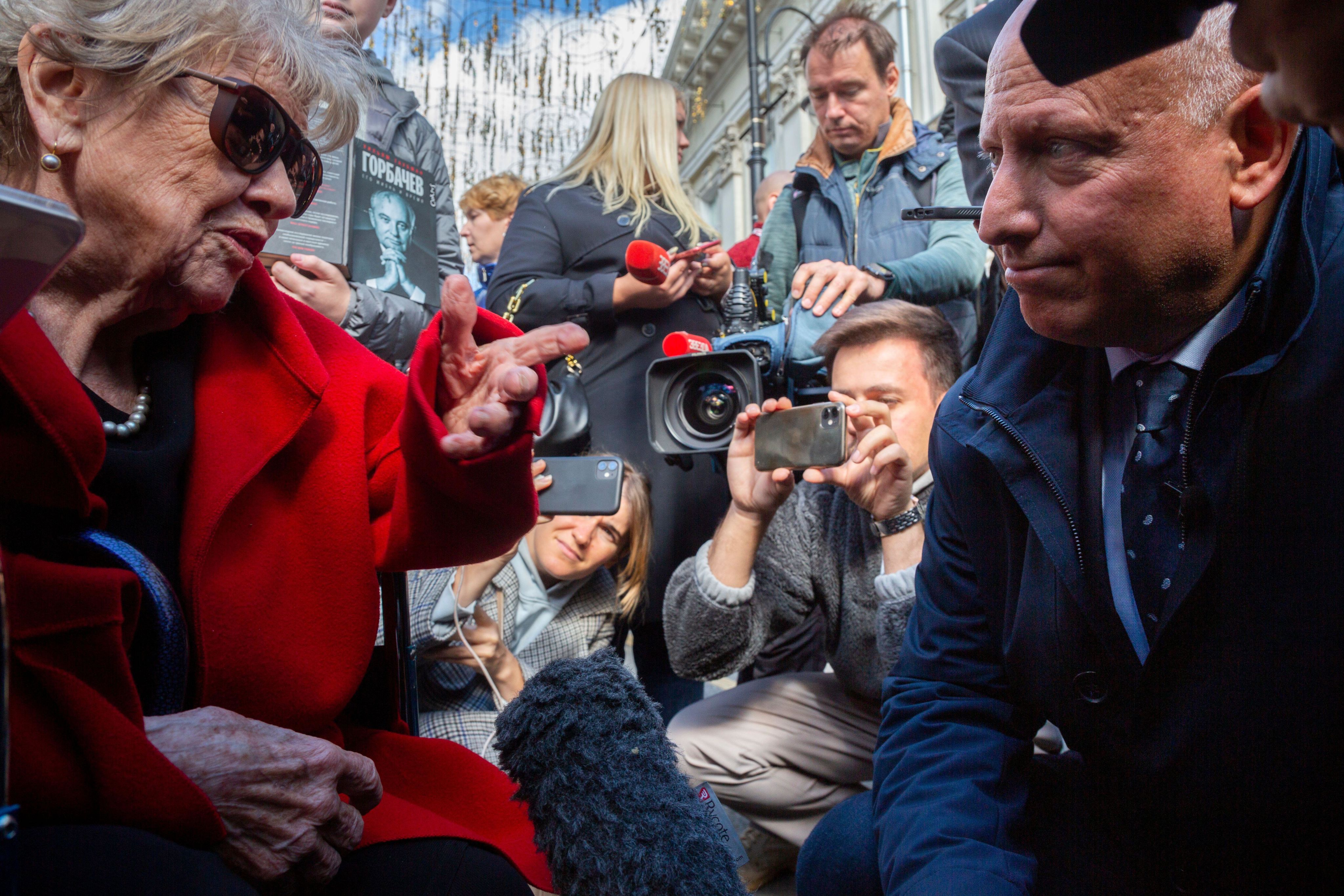Steve Rosenberg holds a microphone before former Ron Suzanne Massie outside Pillar Hall in Moscow