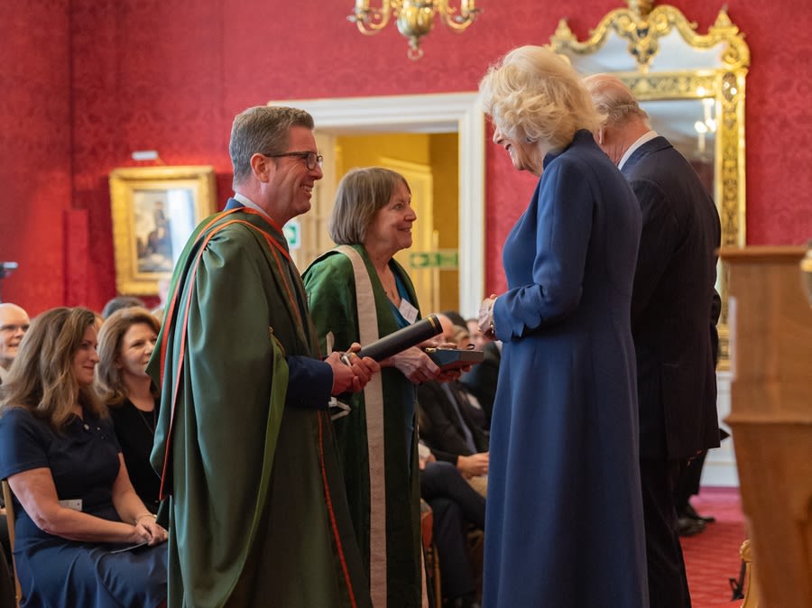 King Charles III and Queen Camilla present Professor Shearer West, Vice-Chancellor and President of the University of Leeds and Professor Stephen Russell, Director of Leeds Institute of Textiles and Colour with the Queen Elizabeth Prize for Education