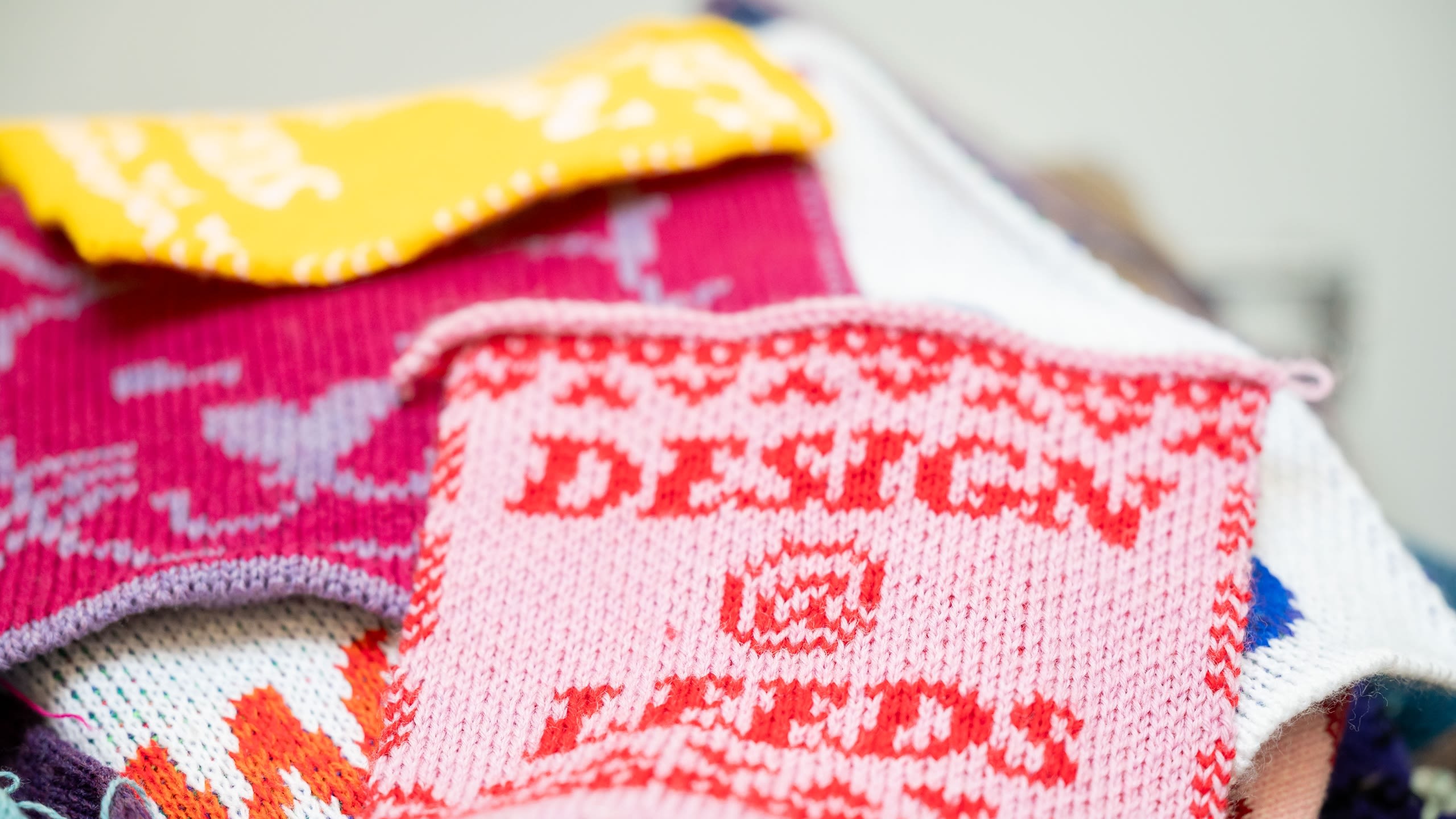 Pieces of knitted textiles in bright colours.