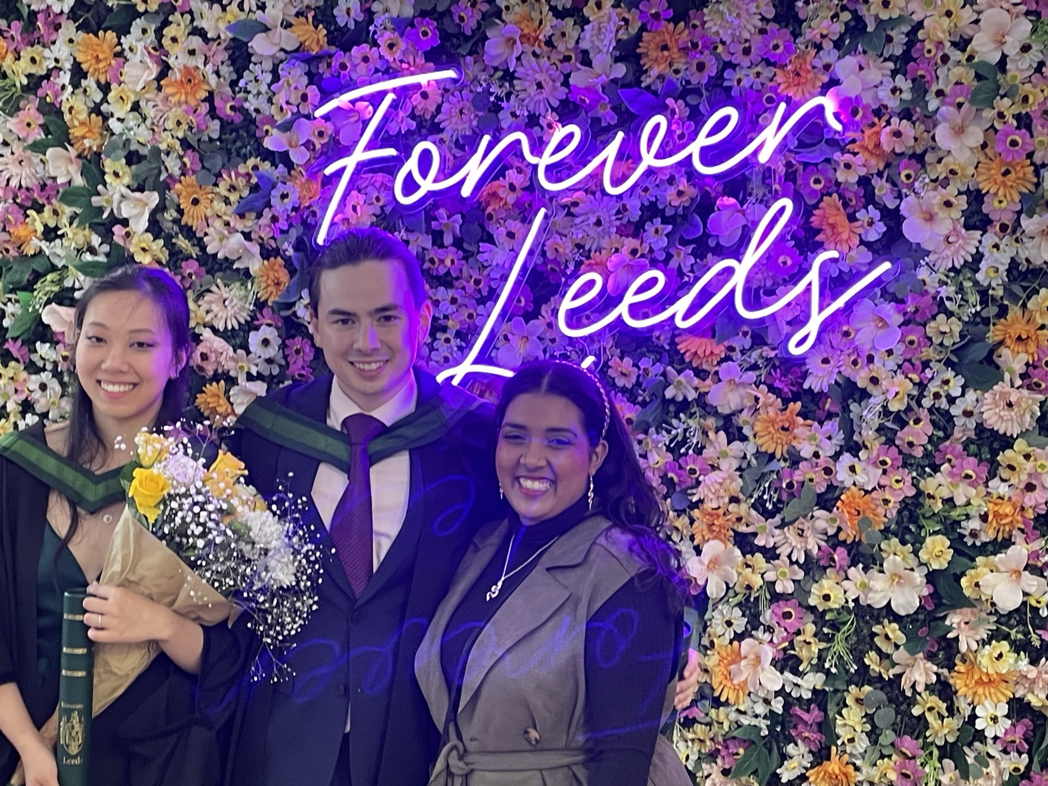 Students sat outside union on picnic table 
