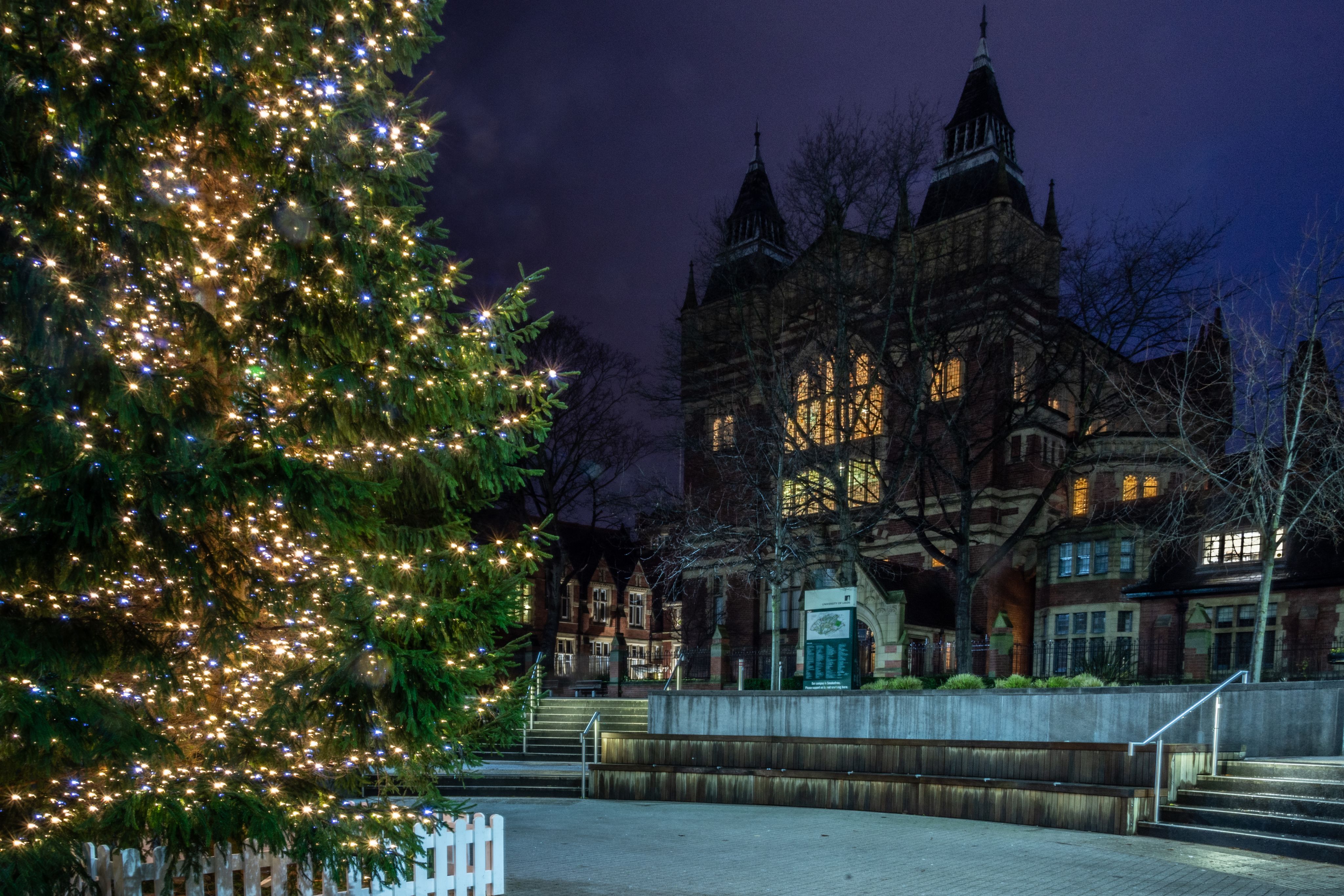 Dr Oluwapelumi Adeyemi holding up a glass flask with liquid inside