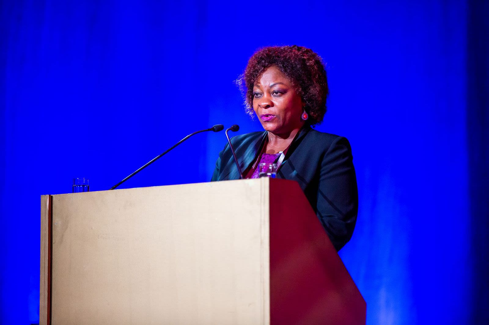 woman standing at lecturn giving speech