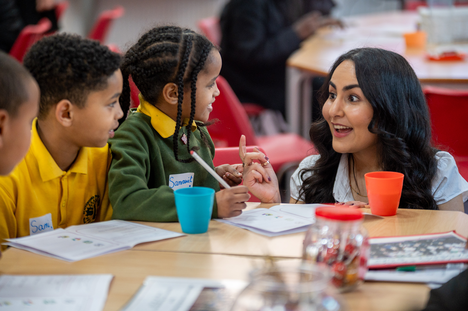 Two children learning with a tutor