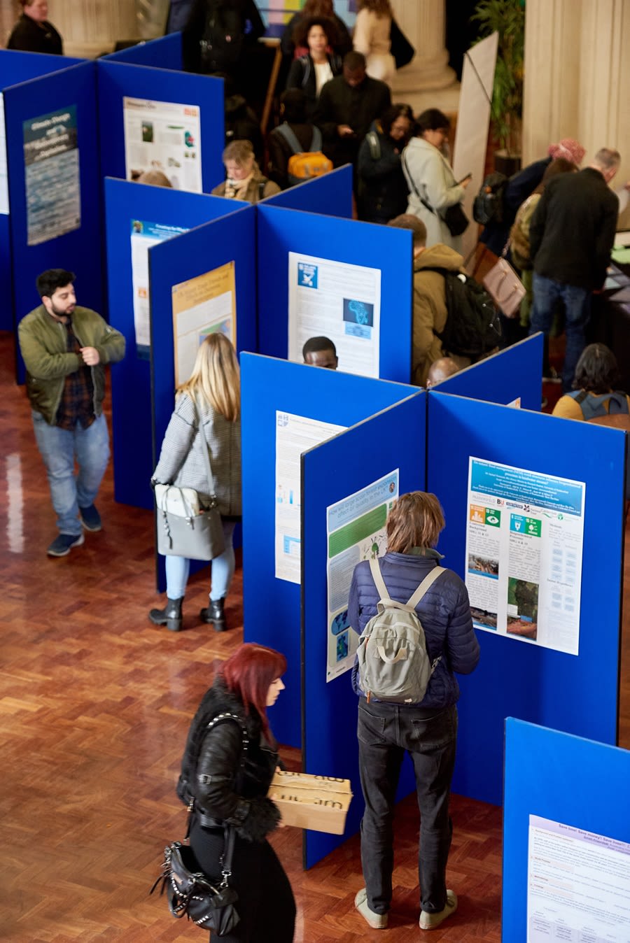 Visitors at an event looking around information boards.