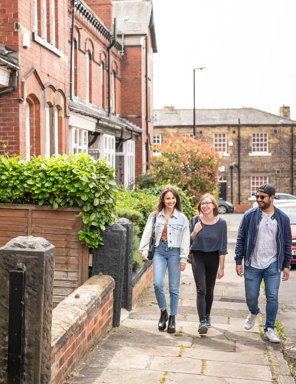 A group of students walking down a residential streets