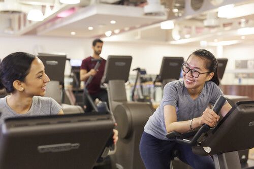 male students sat outside the school of english on wall 