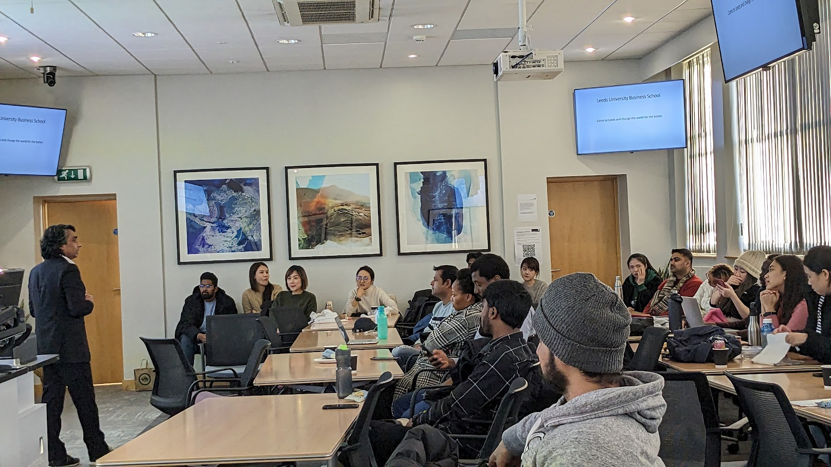 Anith lectures to a group of students