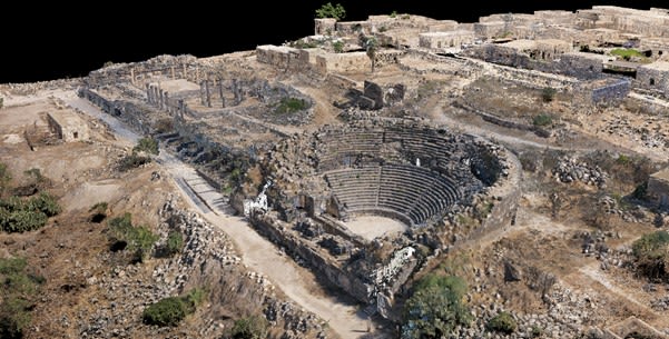 aerial view of the remains of an ancient city showing an amphitheatre. 