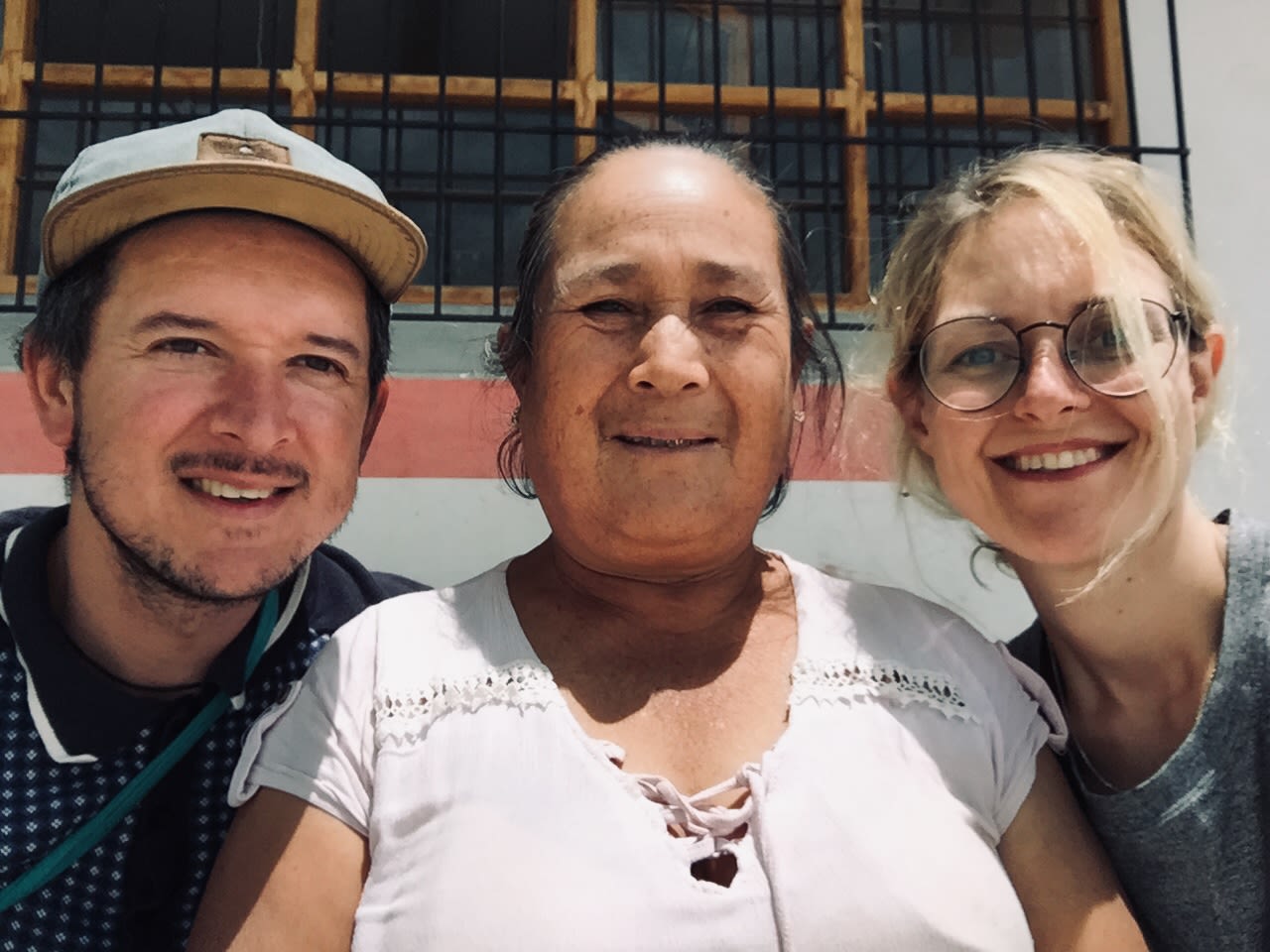 three smiling faces in sunlight.