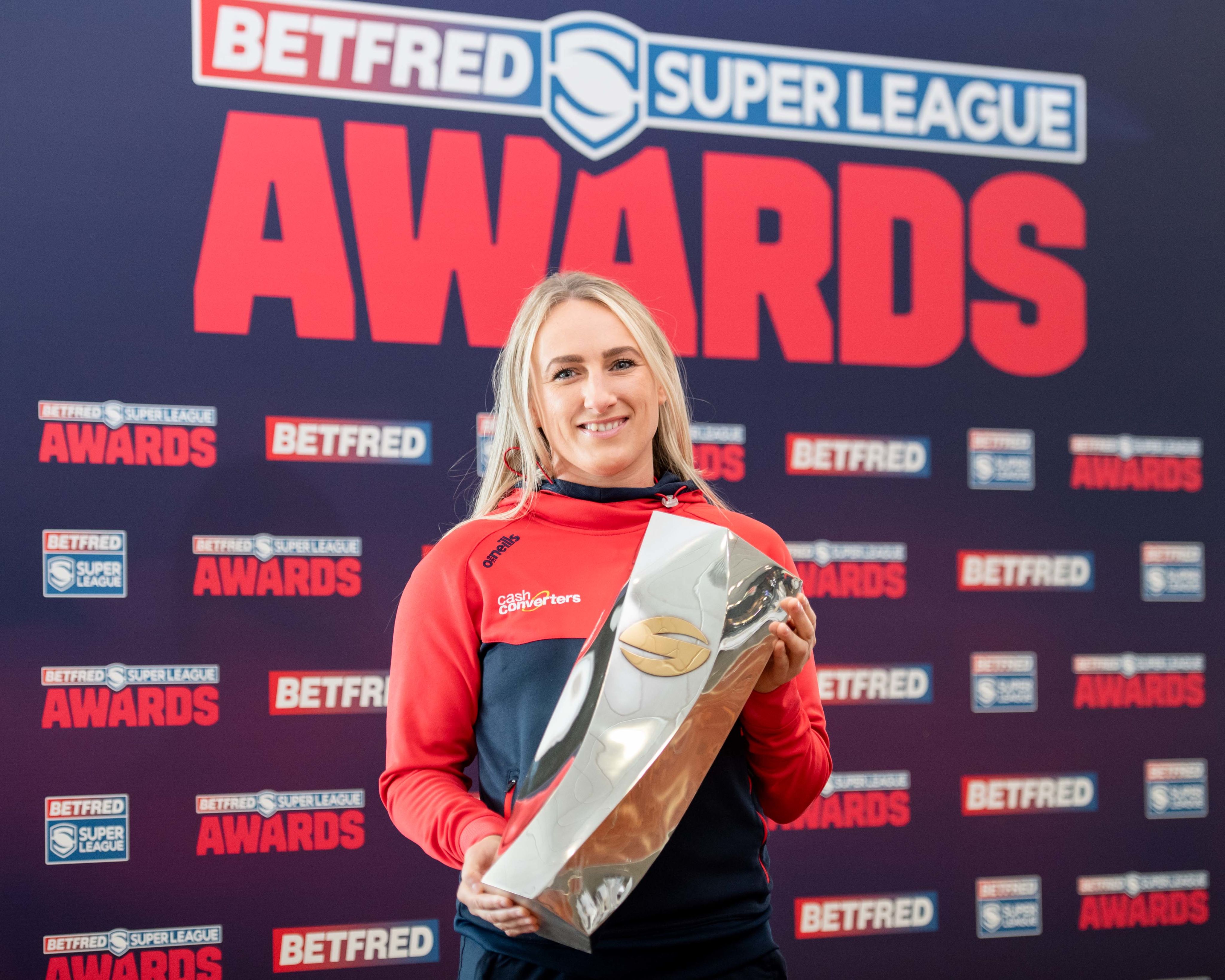 Jodie stands holding the Woman of Steel trophy