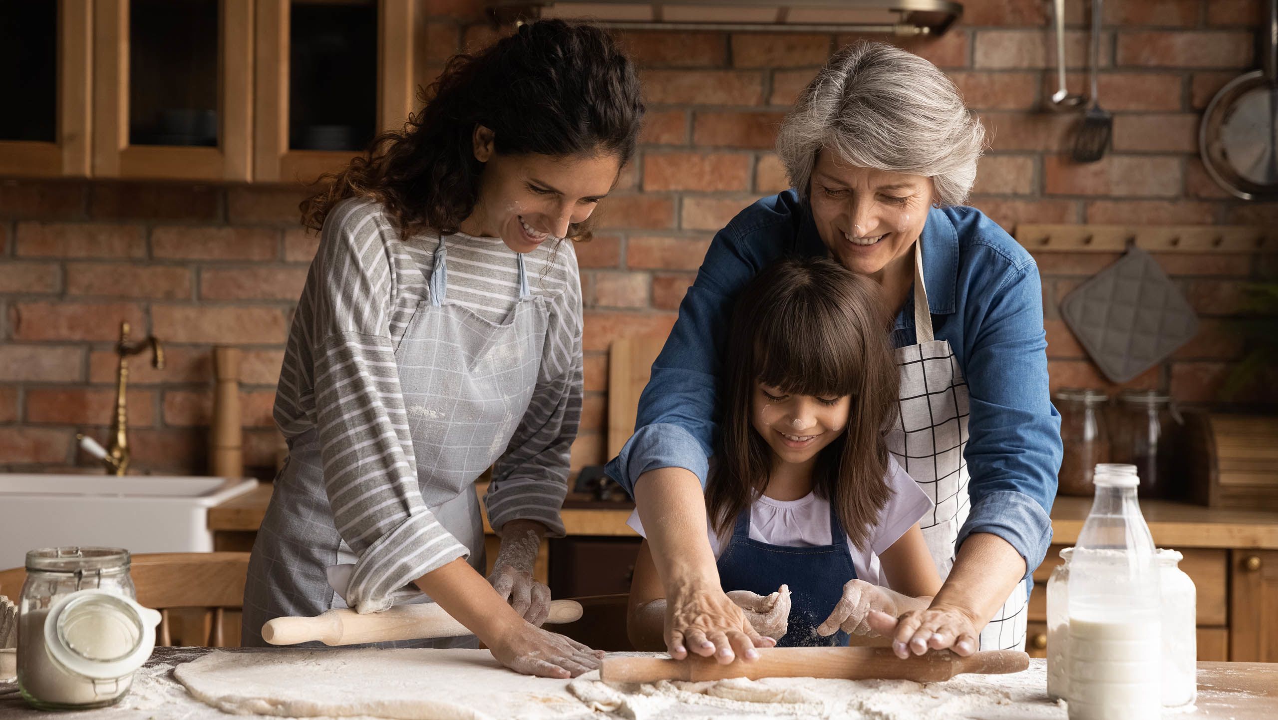Three generations of a family baking together in a kitchen