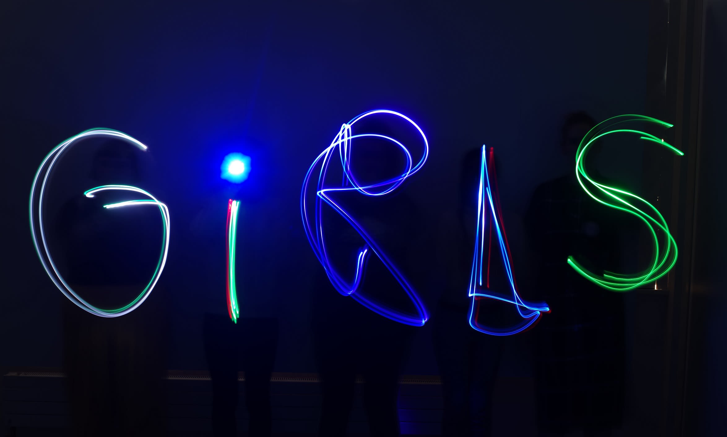 A light installation that reads 'Girls' from the Art School for Rebel Girls
