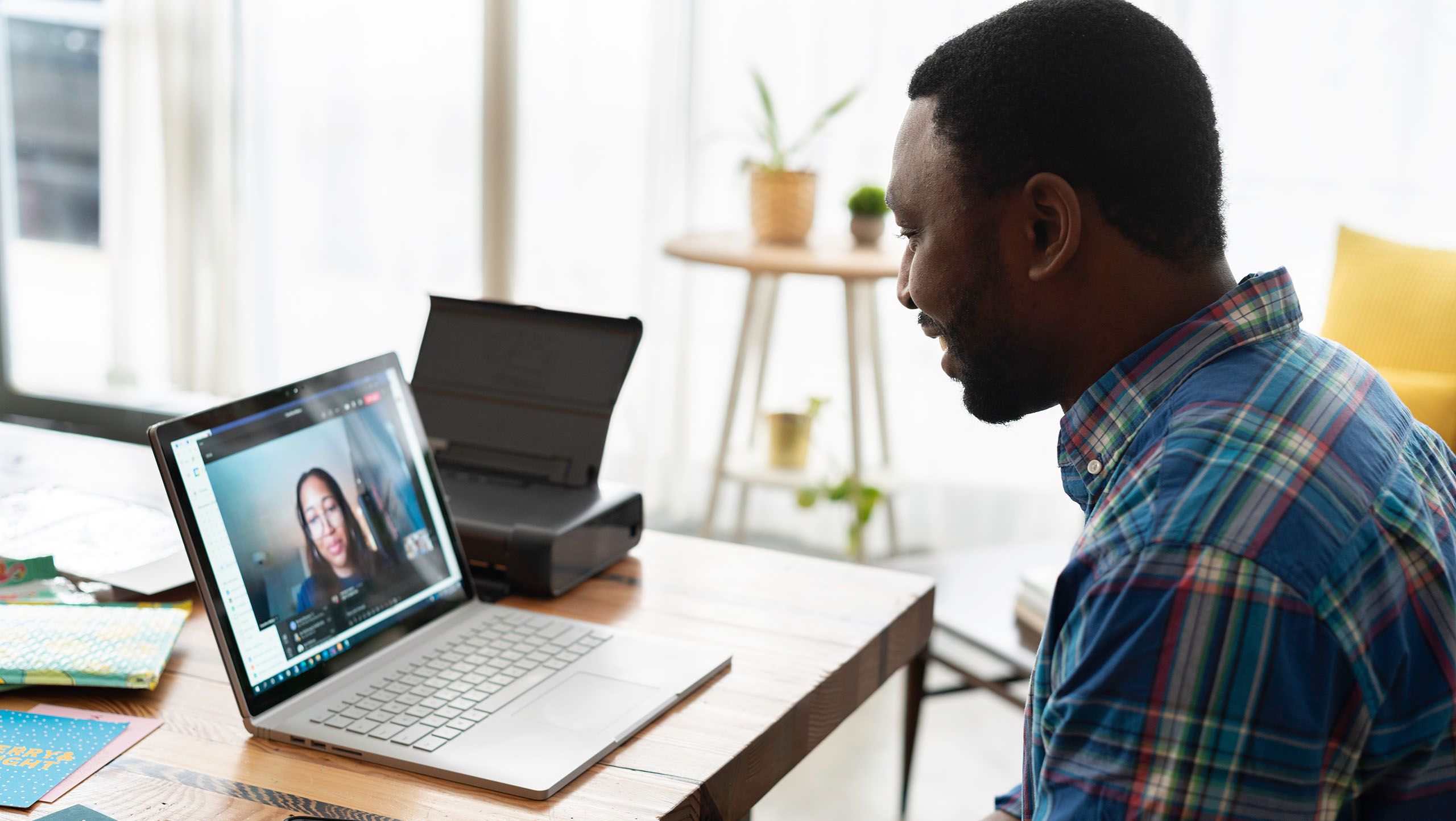 A person talking to someone on a laptop video call