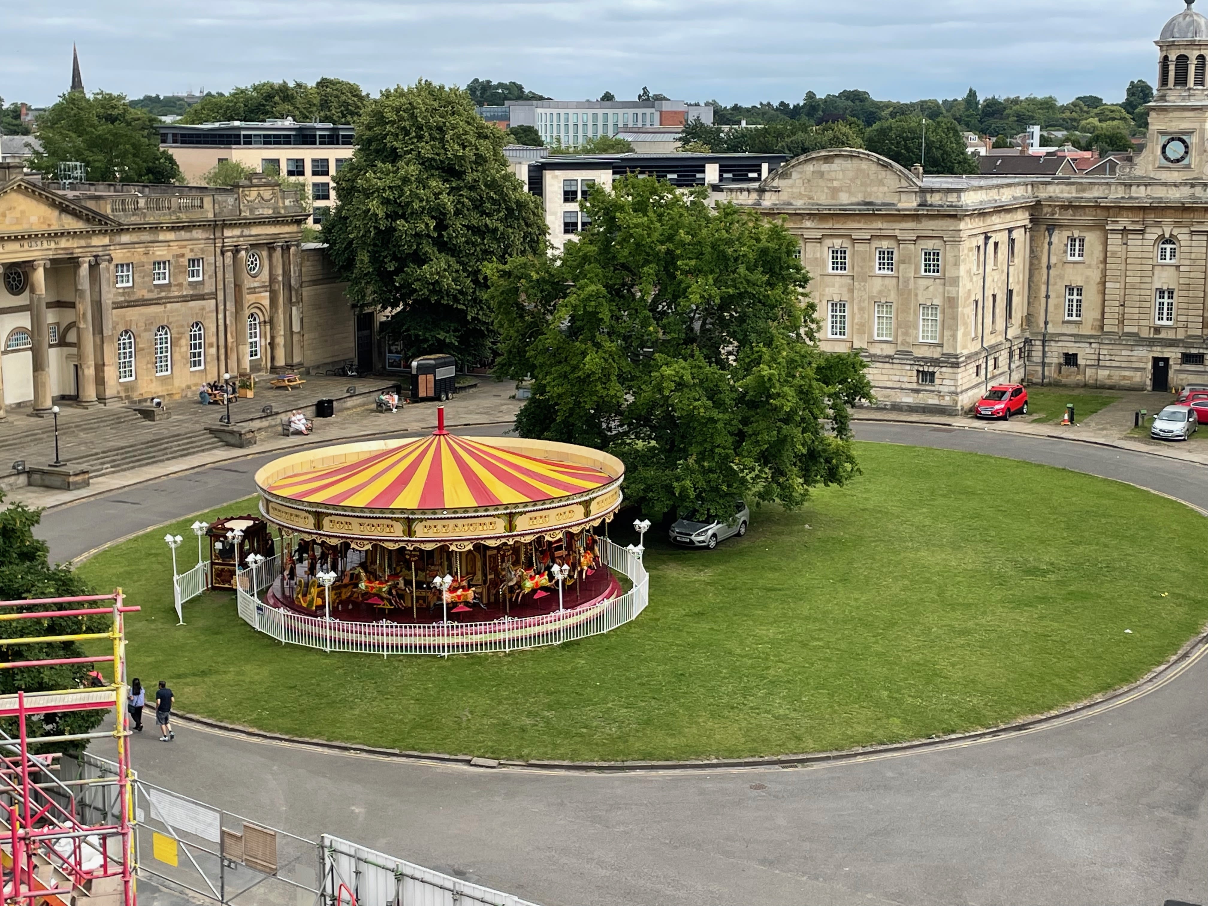 The Eye of York (a circular green with a tree and merry-go-round on it) in the summer