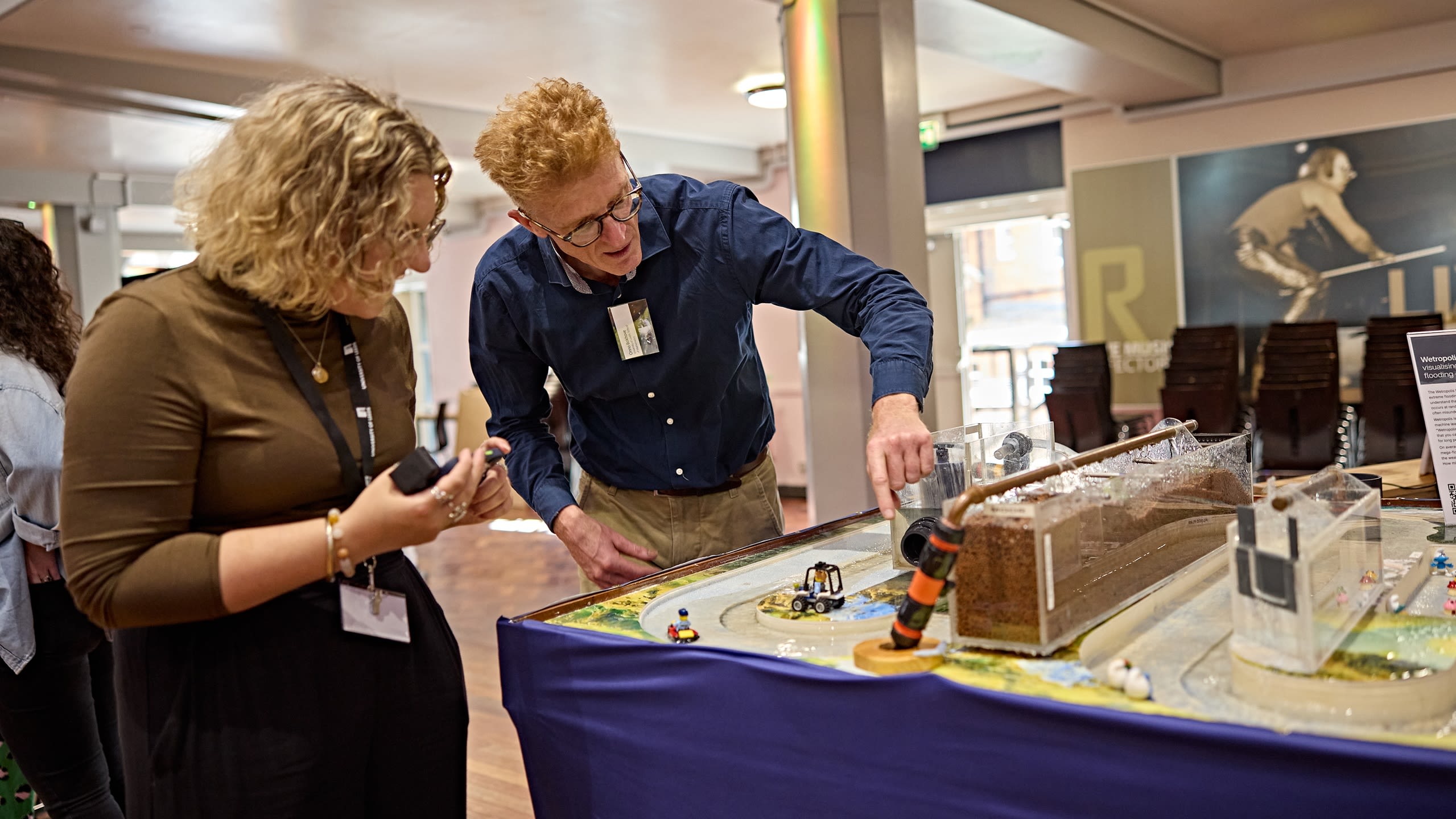 A person demonstrating a 3D model of flood-alleviation engineering solutions.