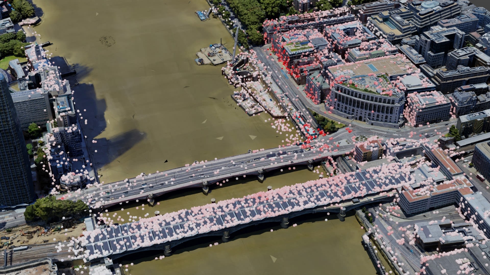 Data points visualised on a geospatial image of a river, a two bridges and the buildings of a city surrounding it